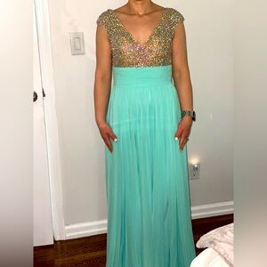 Teal dress. Stones on top.